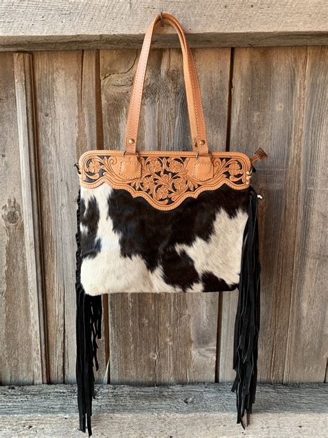 Stylishly bold: Cow print fringe purse for fashion-forward individuals